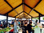 people shopping at the farmers market under the new shelter